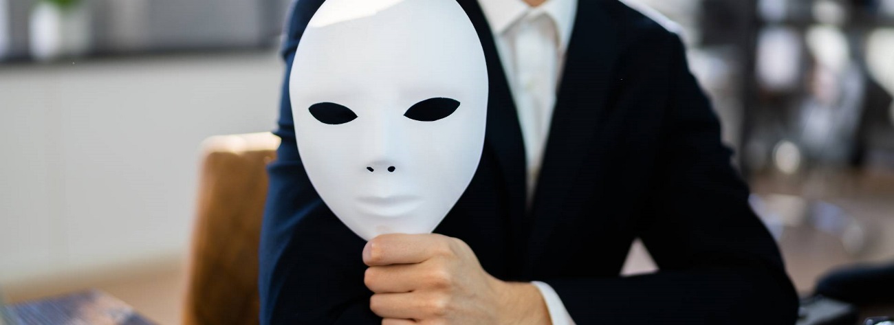 a person holding a mask; concept of phishing scam